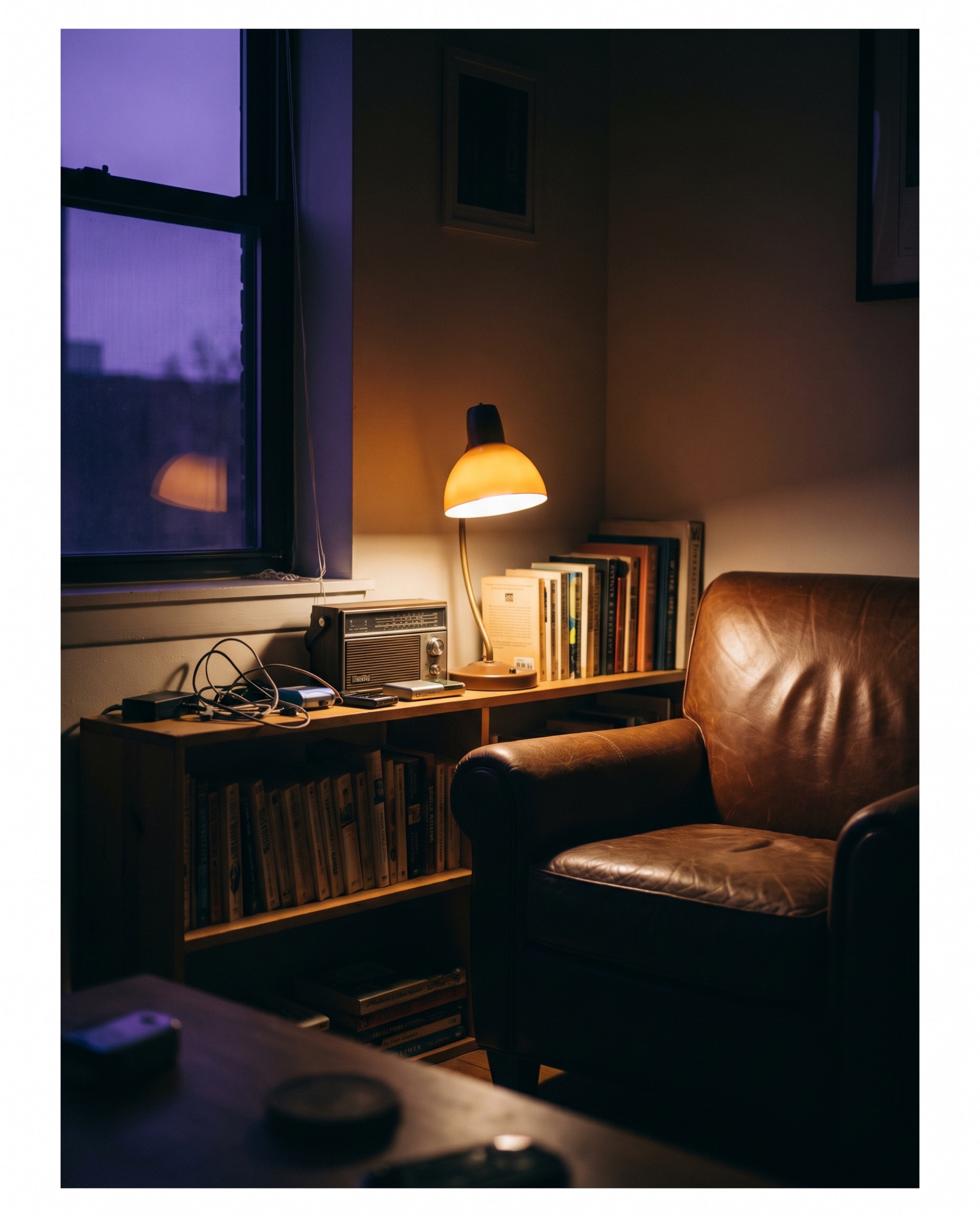 A quiet corner of the studio at night, lit in amber